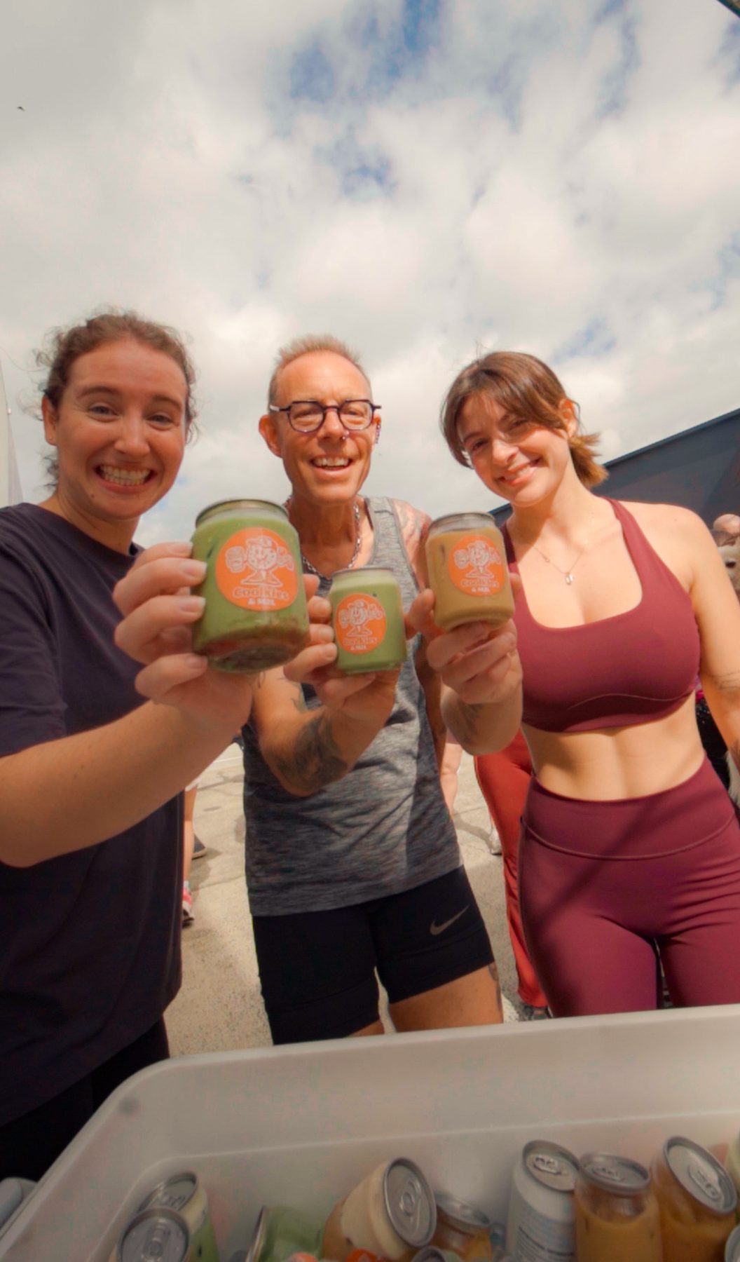 Members smiling with drinks after an event