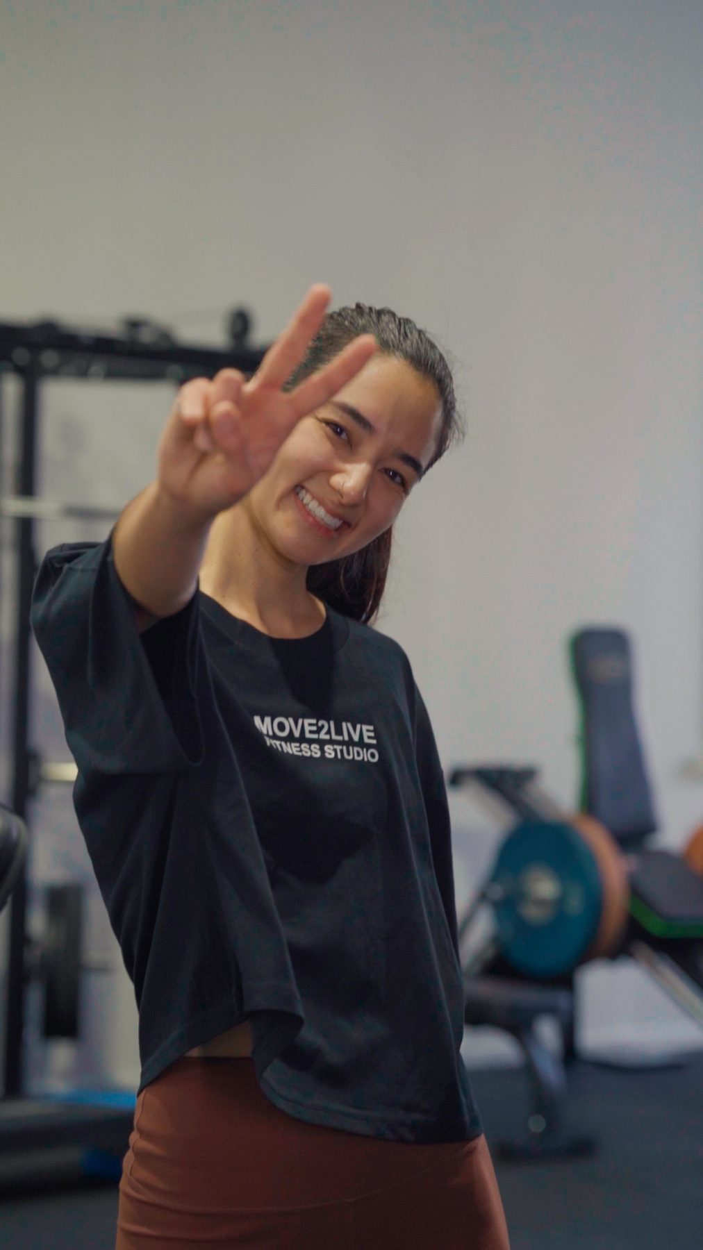 Member smiling and making a peace sign