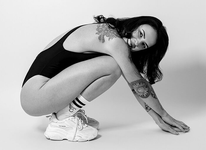 Mari Laureano crouching and smiling